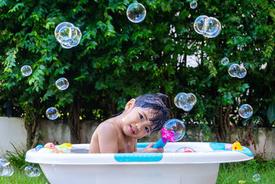 Portrait of smiling boy with bubbles