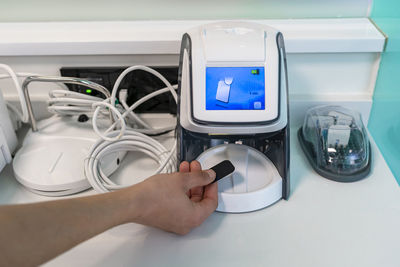 Hand of nurse scanning x-ray in modern machine at clinic