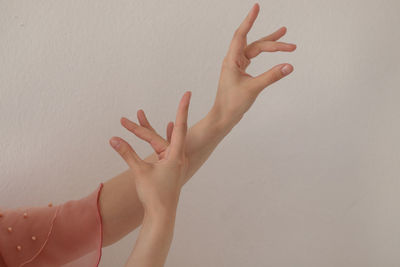 Midsection of woman hand against wall