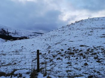 Scenic view of snow covered mountains against sky