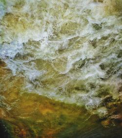 Full frame shot of water flowing through rocks