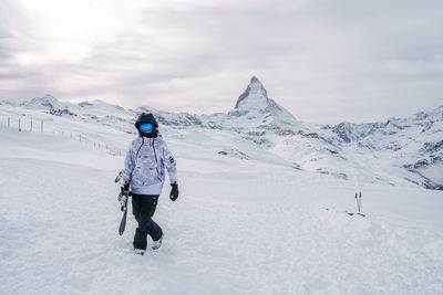 Rear view of man skiing on snow covered mountain