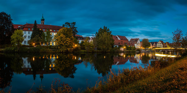 Reflection of trees and buildings in lake