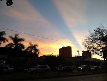 Cars on road at sunset