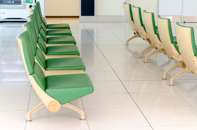 Empty chairs against tiled floor