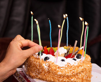 Close-up of hand holding cake