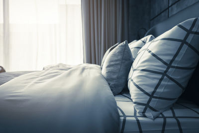 Pillows and blanket on bed at home