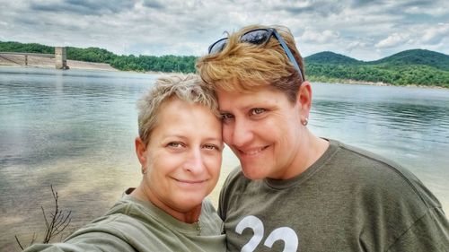 Portrait of smiling man and woman in water