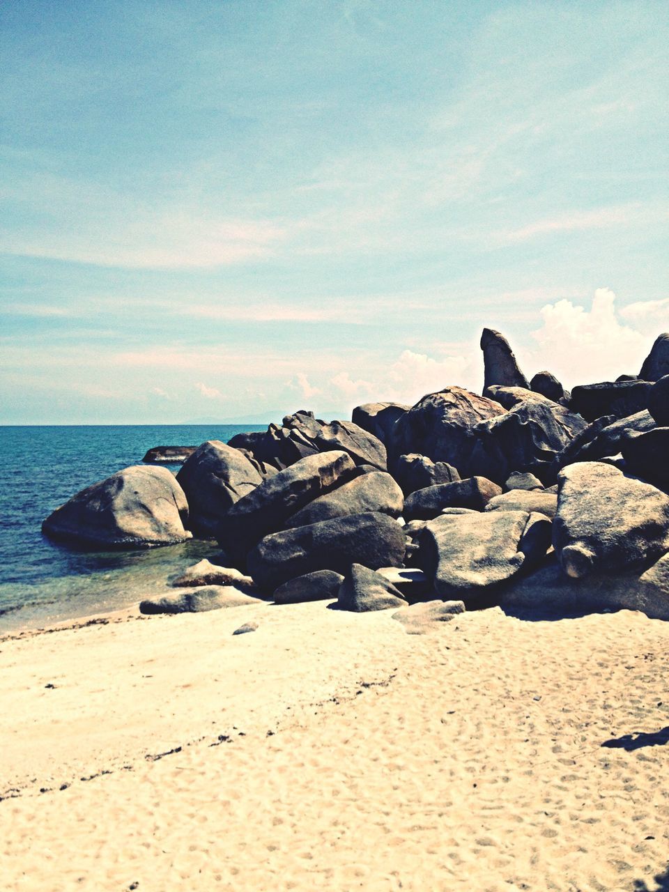 sea, beach, water, tranquil scene, horizon over water, shore, tranquility, sky, scenics, rock - object, beauty in nature, nature, sand, coastline, rock formation, rock, idyllic, calm, remote, stone - object