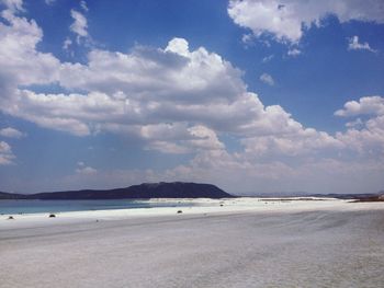 View of beach against cloudy sky