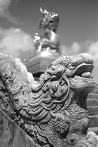 Close-up of statue against temple building