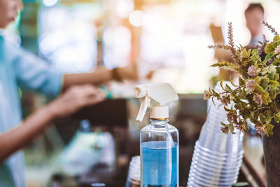Midsection of woman holding bottle