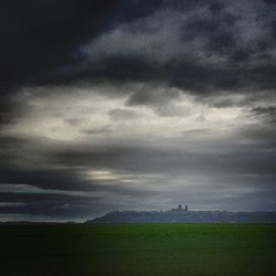 Scenic view of landscape against cloudy sky