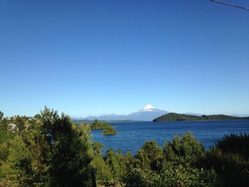 Scenic view of mountains against clear blue sky