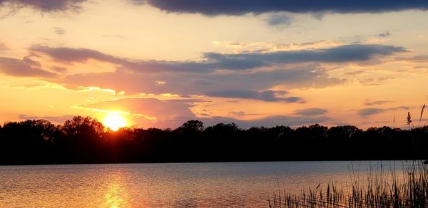 Scenic view of lake against romantic sky at sunset