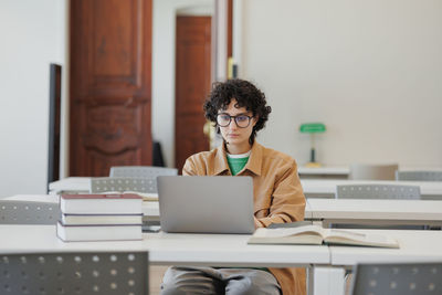 Young man using laptop at office