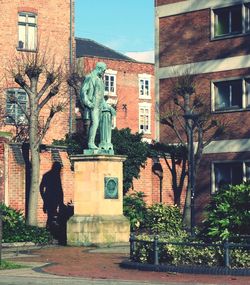 Statue against building in city