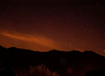 Scenic view of silhouette mountain against sky at night