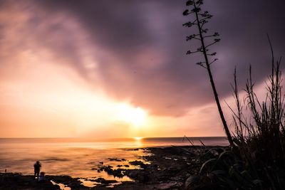 Scenic view of sea against sky at sunset