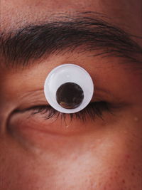 Cropped image of person with artificial eyeball