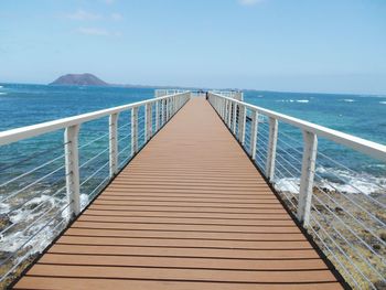 Pier over sea against sky