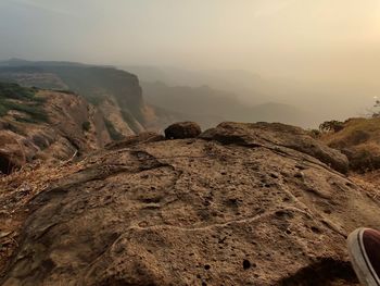 Rock formations on landscape against sky