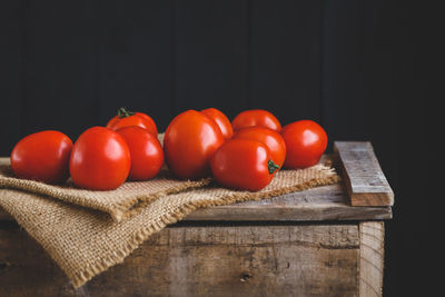 Close-up of tomatoes over black background