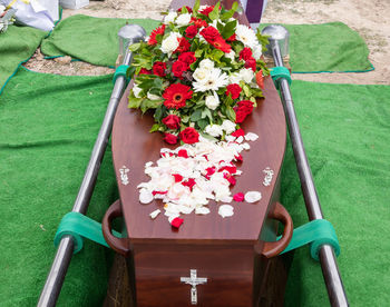 Closeup shot of a funeral casket or coffin in a hearse or chapel or burial at cemetery
