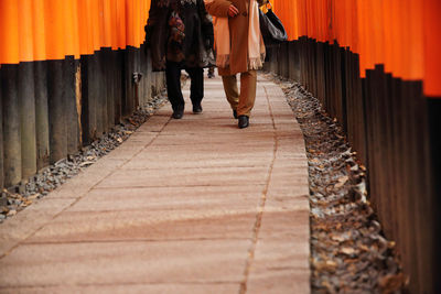 Low section of man walking on zebra crossing