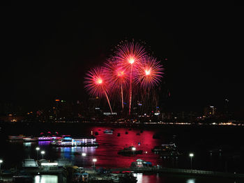 Firework display over river at night