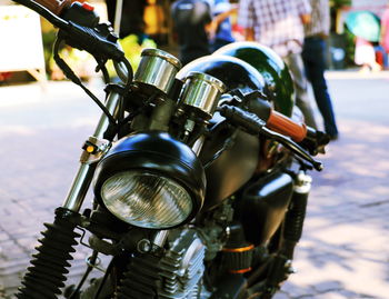 Close-up of motorcycle on street in city