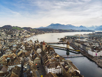 High angle view of townscape by sea against sky