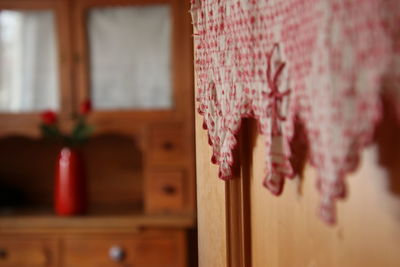 Close-up of pink hanging on door at home