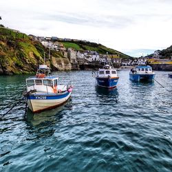 Boats sailing in sea against sky