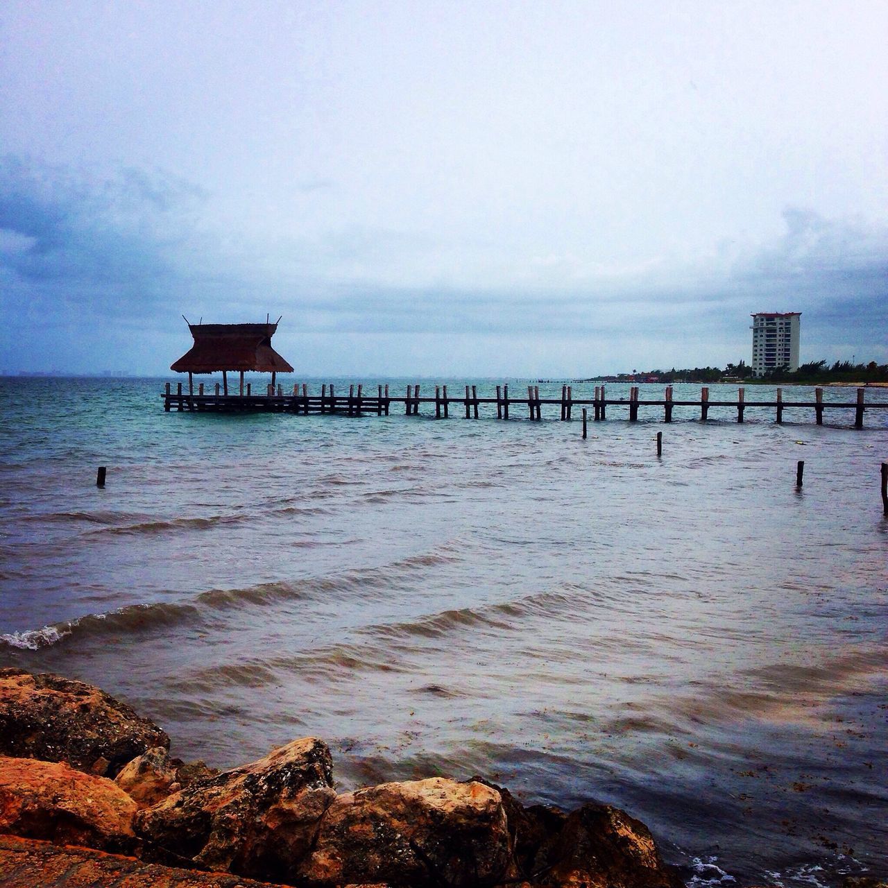 sea, water, horizon over water, built structure, pier, sky, tranquil scene, architecture, tranquility, scenics, beauty in nature, beach, nature, shore, idyllic, lighthouse, jetty, calm, cloud - sky, rippled