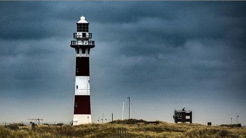 Low angle view of lighthouse on field