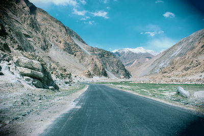 Country road leading towards mountains