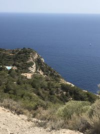 High angle view of sea and mountains against sky