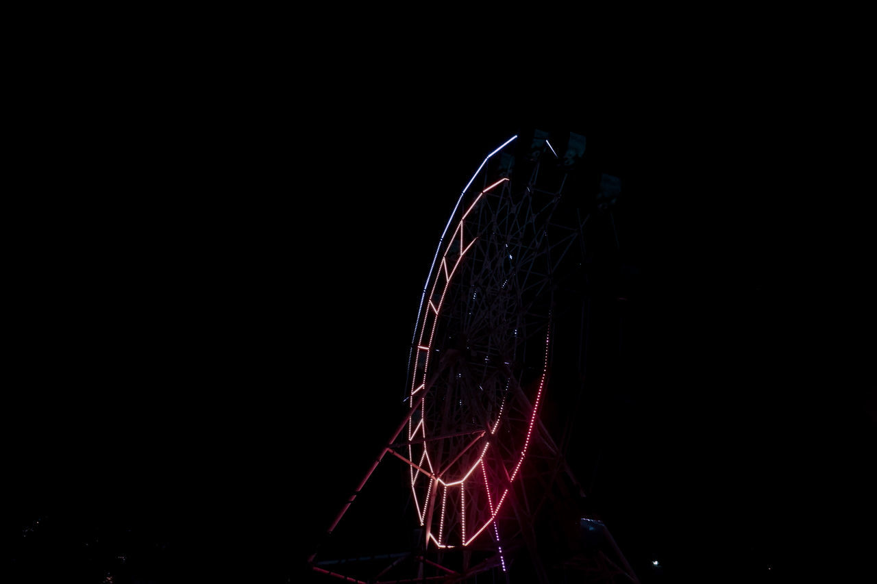 LOW ANGLE VIEW OF ILLUMINATED FERRIS WHEEL AGAINST SKY