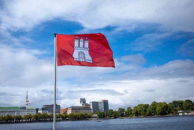 The red flag of hamburg flies at the binnenalster