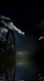 Low angle view of ferris wheel against sky