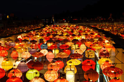 High angle view of many multi coloured paper lanterns in city at night