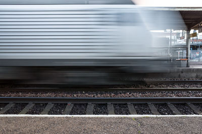 Blurred motion of train at railroad station platform