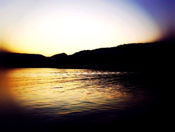 Scenic view of lake at sunset