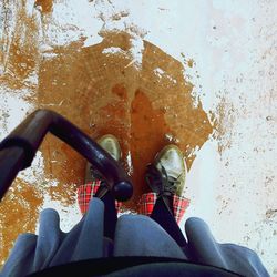 Low section of man standing on water