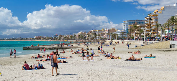 People on beach against sky