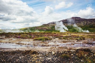 Scenic view of mountain against cloudy sky
