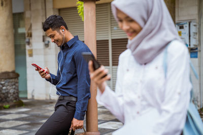 Side view of man using mobile phone