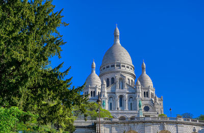 Low angle view of church against blue sky