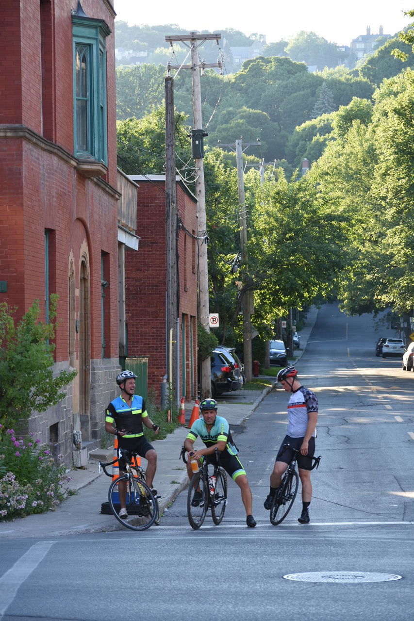 BICYCLES PARKED ON STREET BY BUILDINGS
